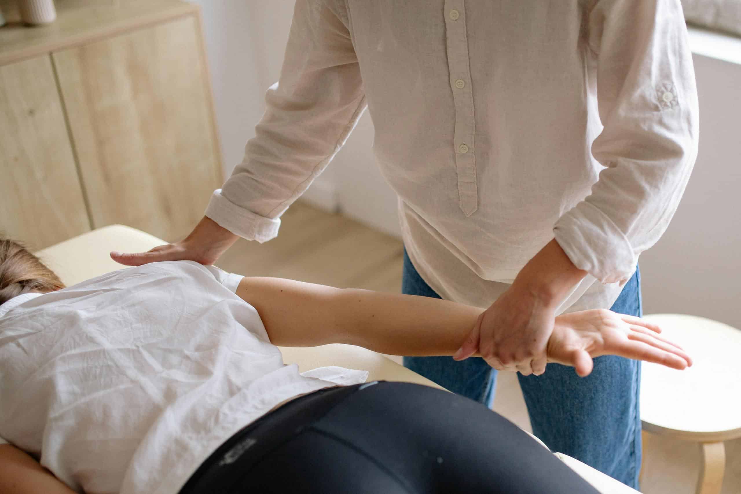 A patient receiving injury recovery in a therapy session.