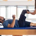 Man and woman engaging in a physical therapy session, focusing on prosthetic leg recovery and injury rehabilitation.